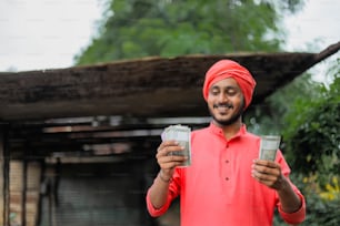 Young indian farmer counting money