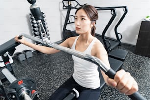 Asian young woman training in the gym