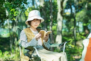 Solo camp image-Young woman reading a book