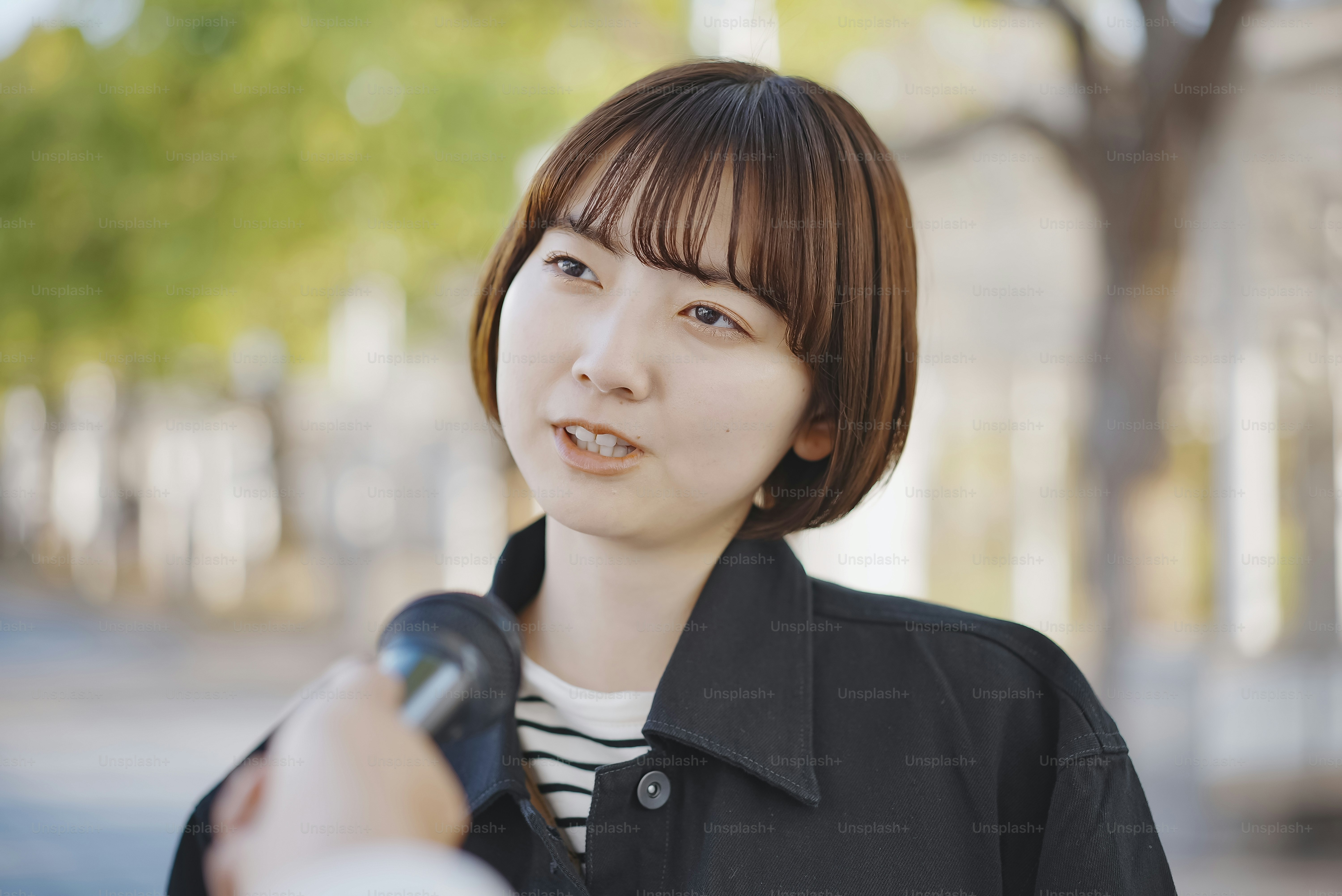 Asian young woman interviewed on the street of the city