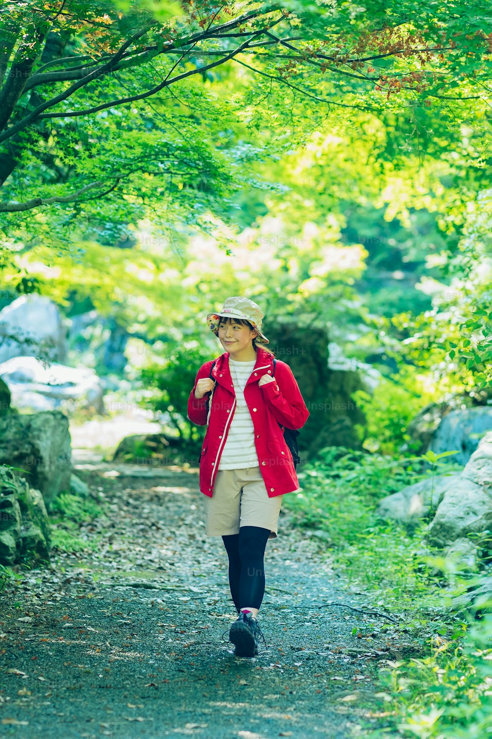 Young woman walking in the fresh green mountain