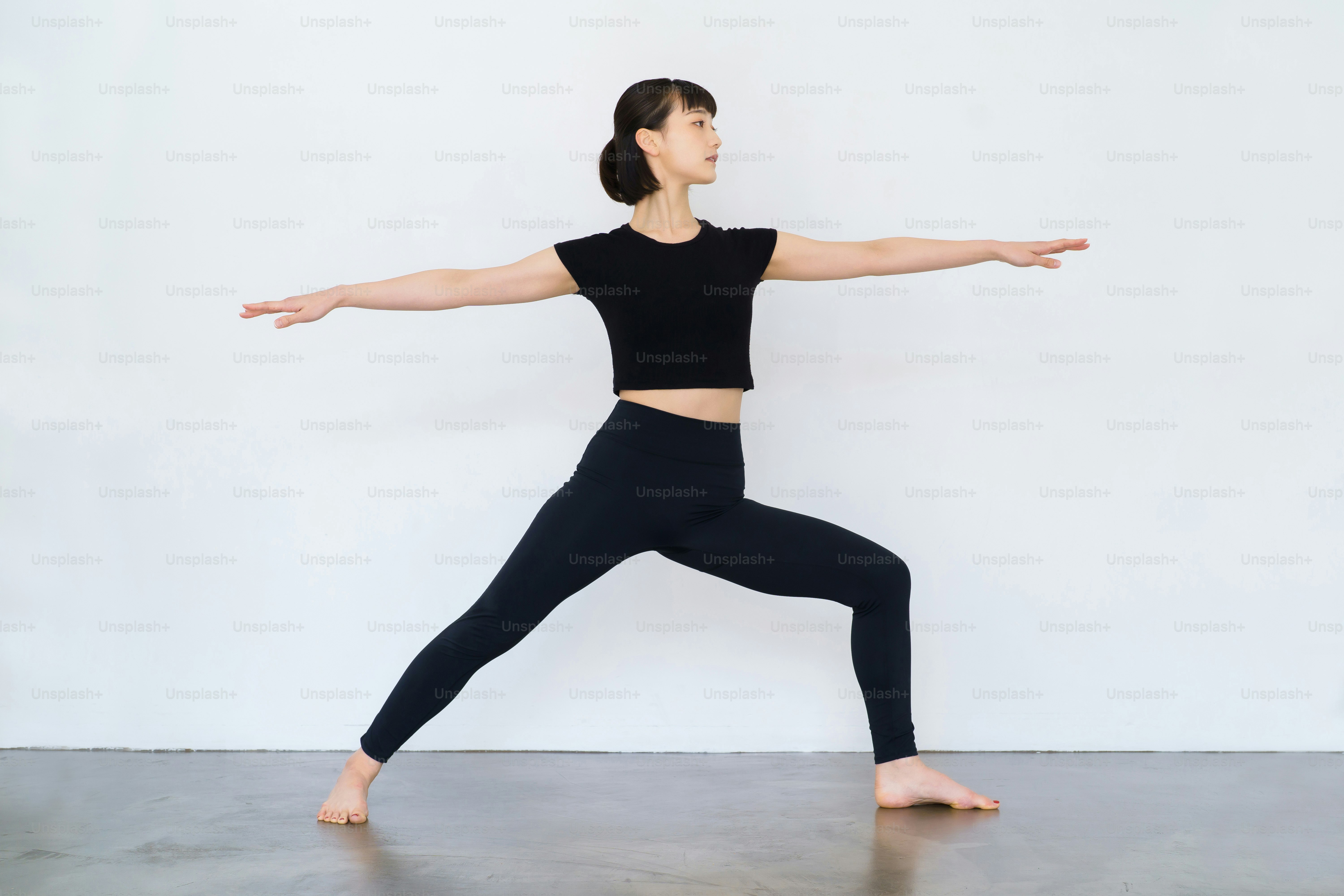 Young woman doing yoga (warrior pose)
