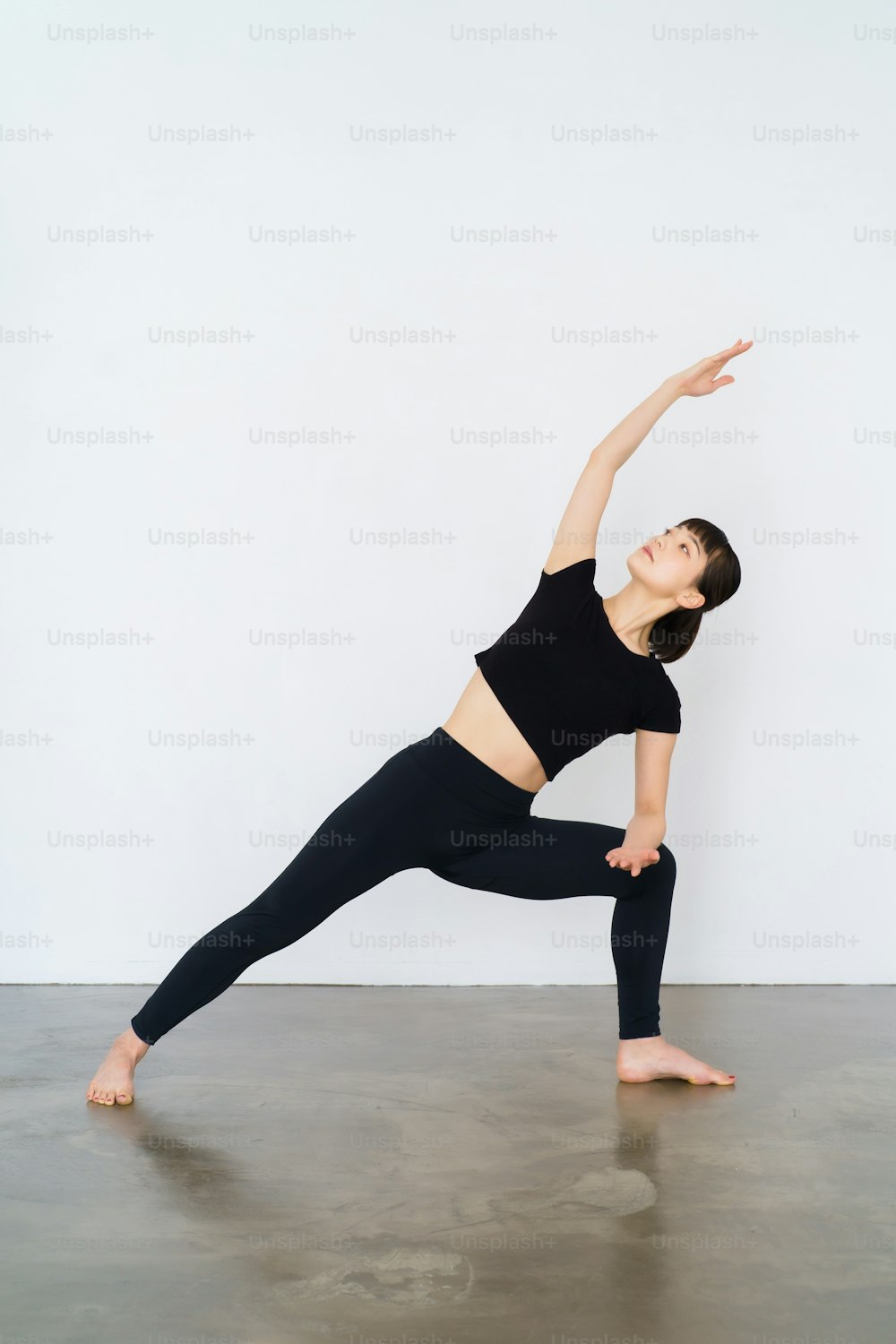 Young woman doing yoga (triangular pose)