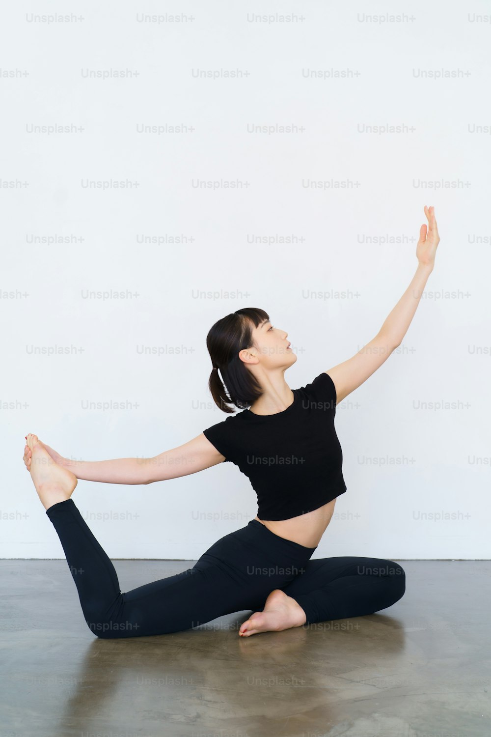 Young woman doing yoga (dove pose)