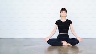 Asian young woman doing mantra meditation in yoga pose