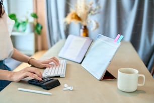 close up of a woman's hand operating a tablet PC in the room