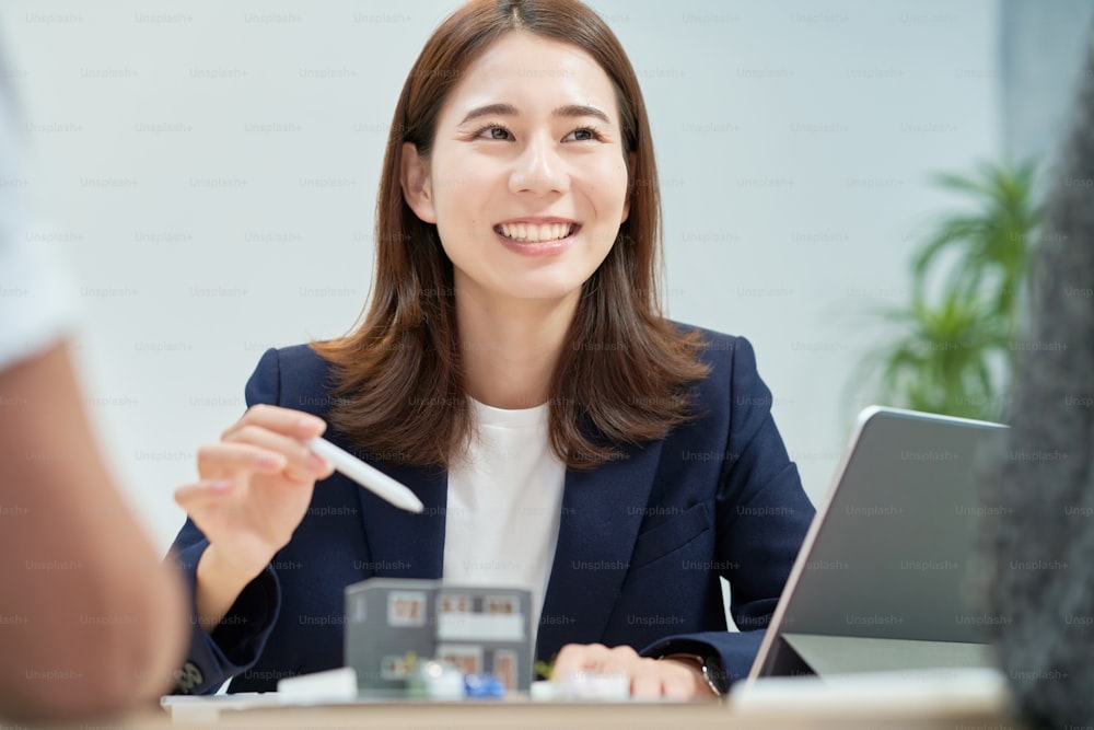 Young woman in a suit who sells real estate