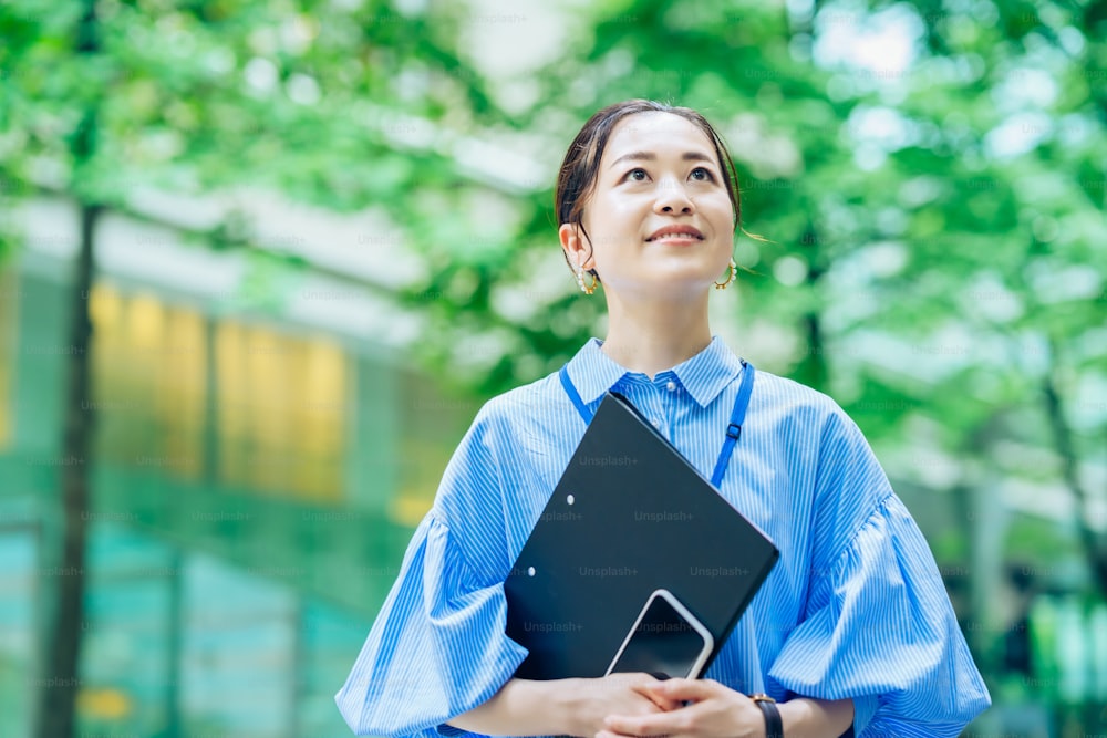 Outdoor portrait of a business woman at greenful business street