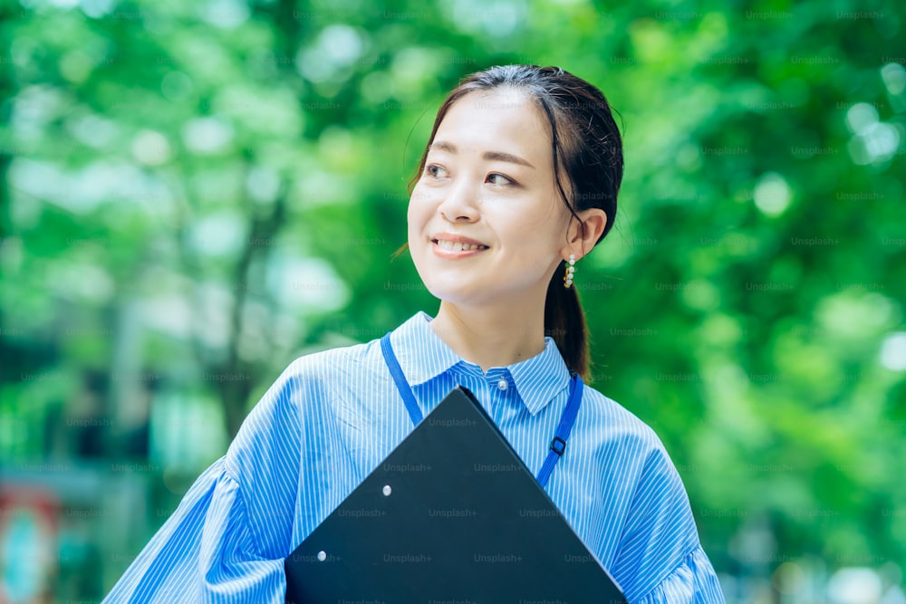 Outdoor portrait of a business woman at greenful business street