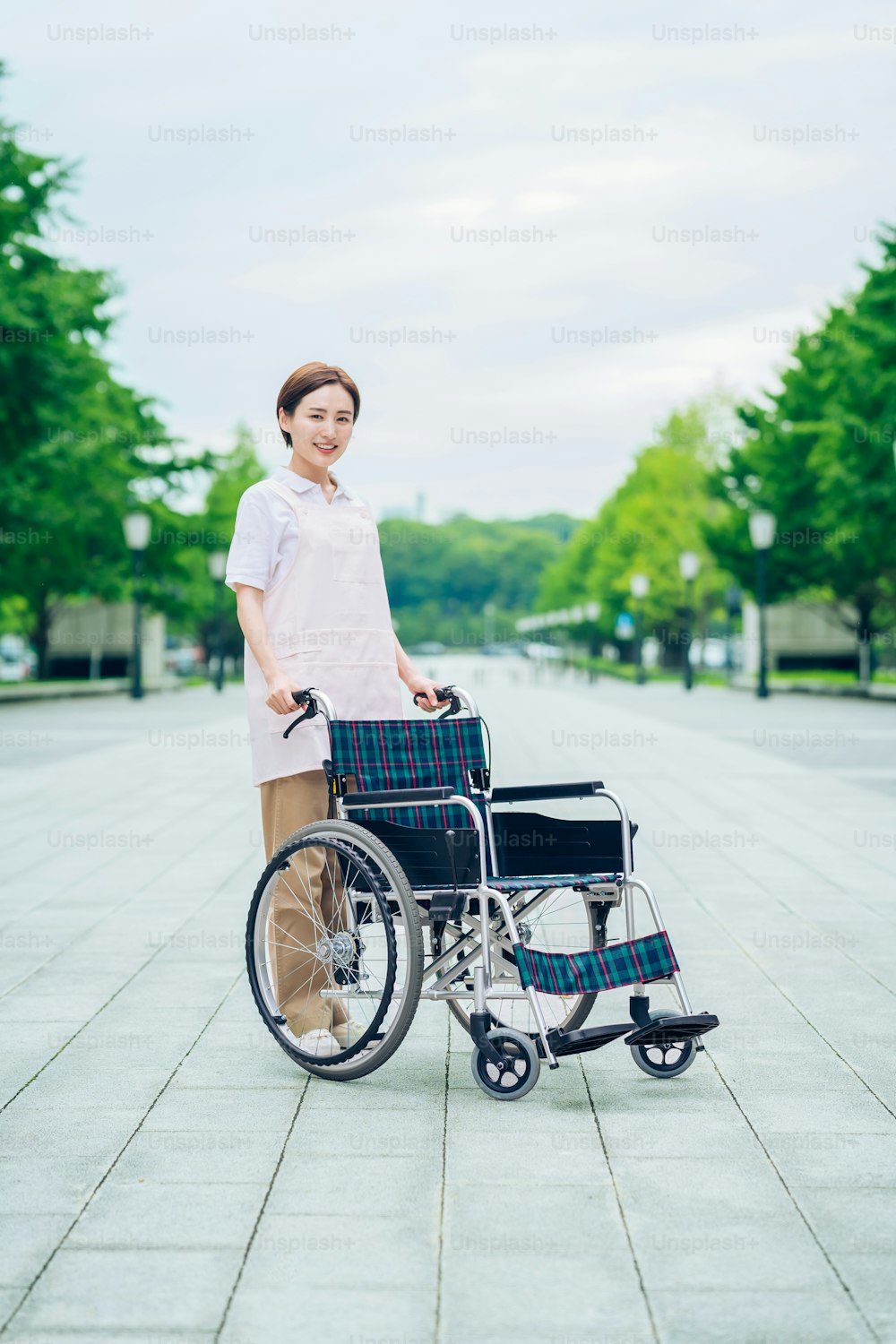 Woman in an apron and wheelchair outdoors