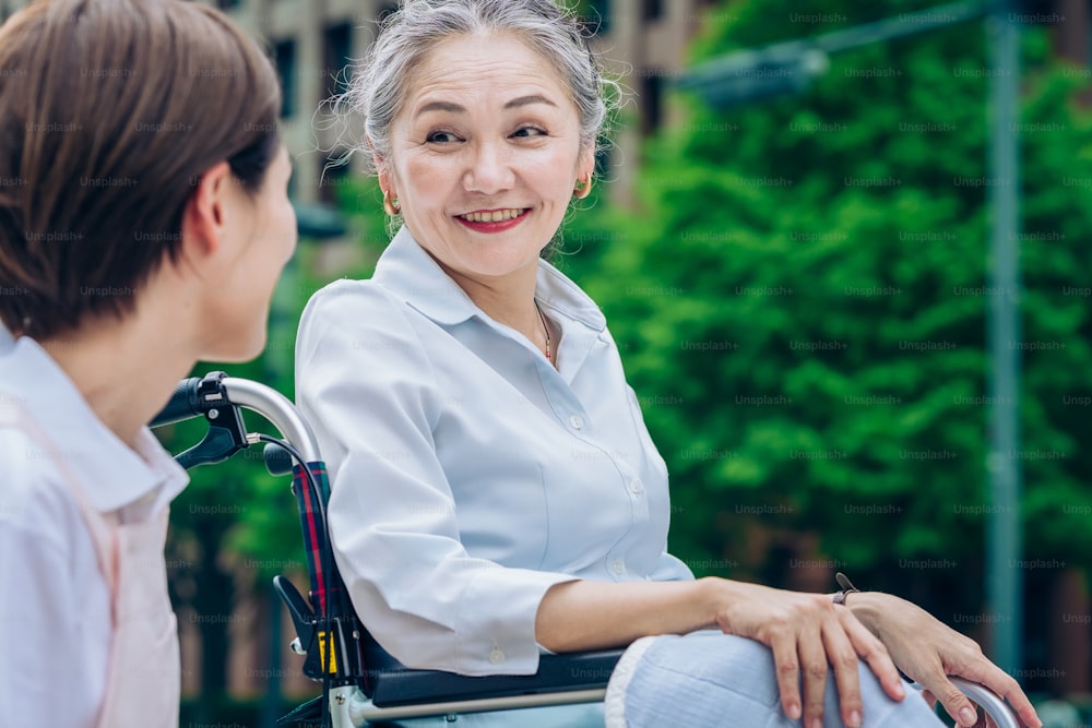 Senior woman riding a wheelchair and talking with a smile