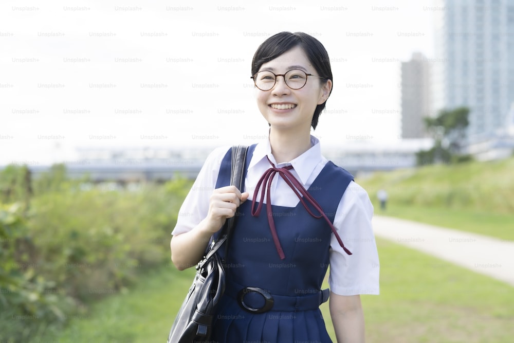 Asian high school girls wearing uniforms and smiling at school