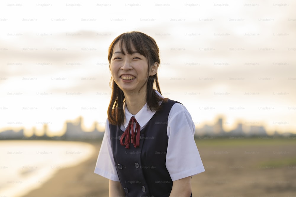 Asian female high school student walking on the beach