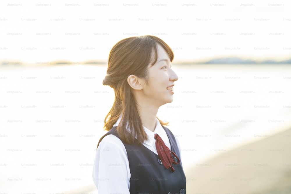 Asian female high school student wrapped in the setting sun