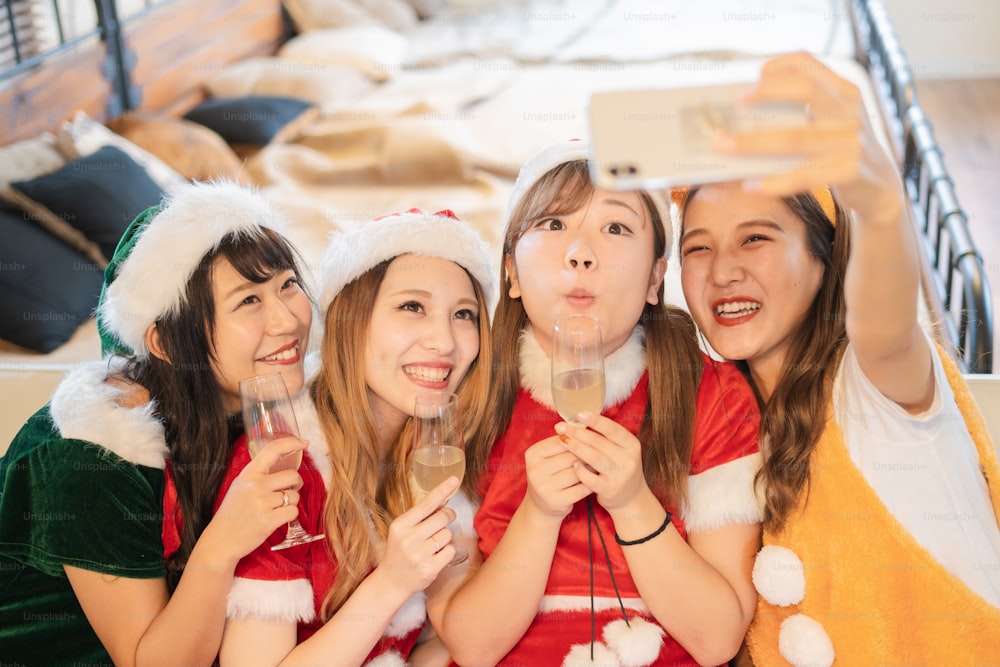 Asian young women wearing Christmas costumes and having a party