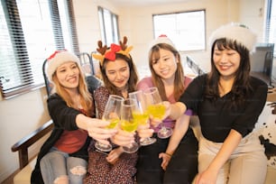 Asian young women wearing Christmas costumes and having a party