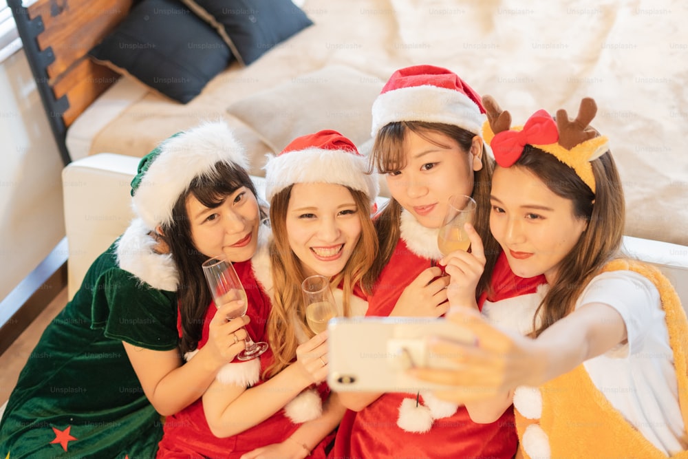 Asian young women wearing Christmas costumes and having a party