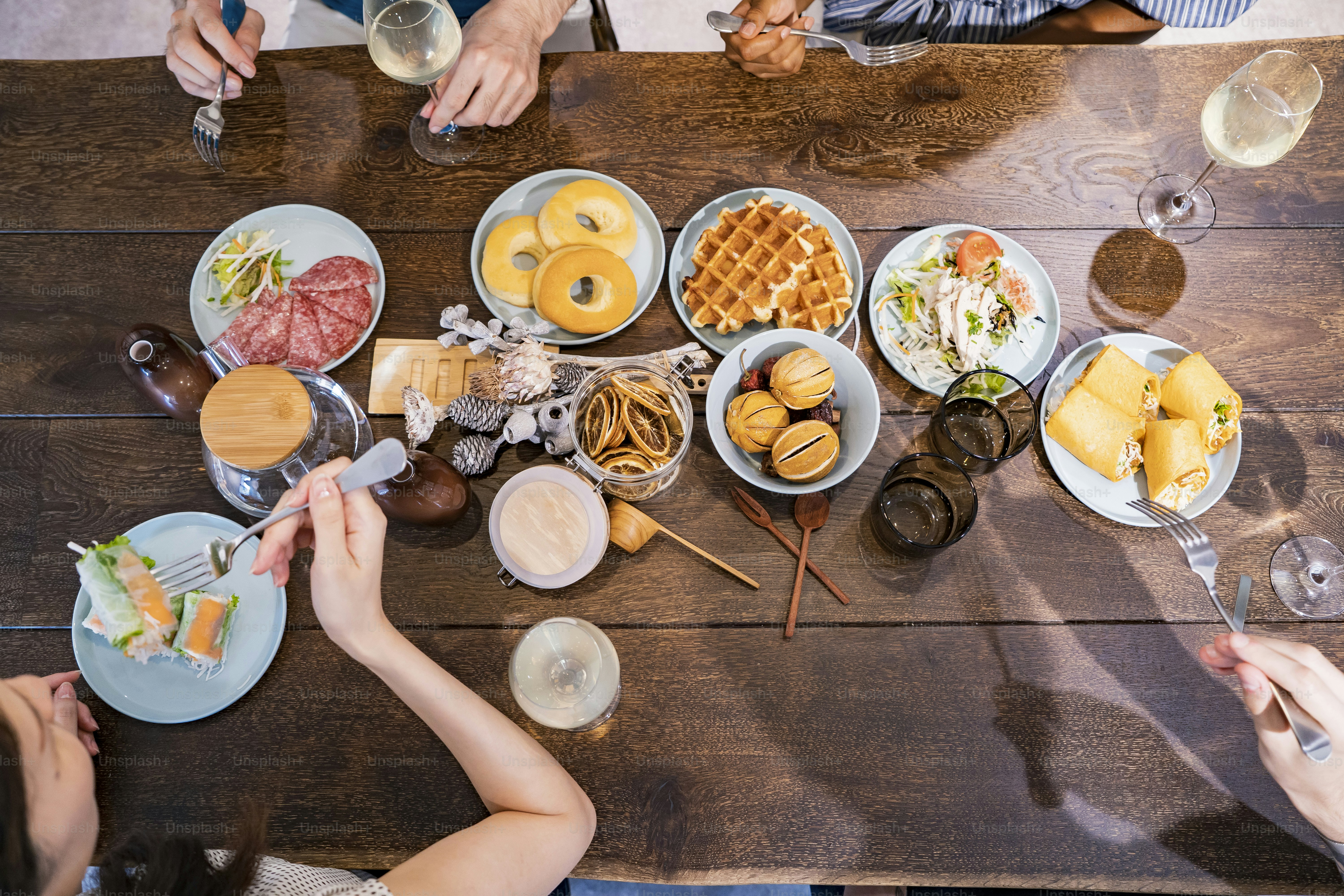 Scene of a home party where men and women surround the dining table