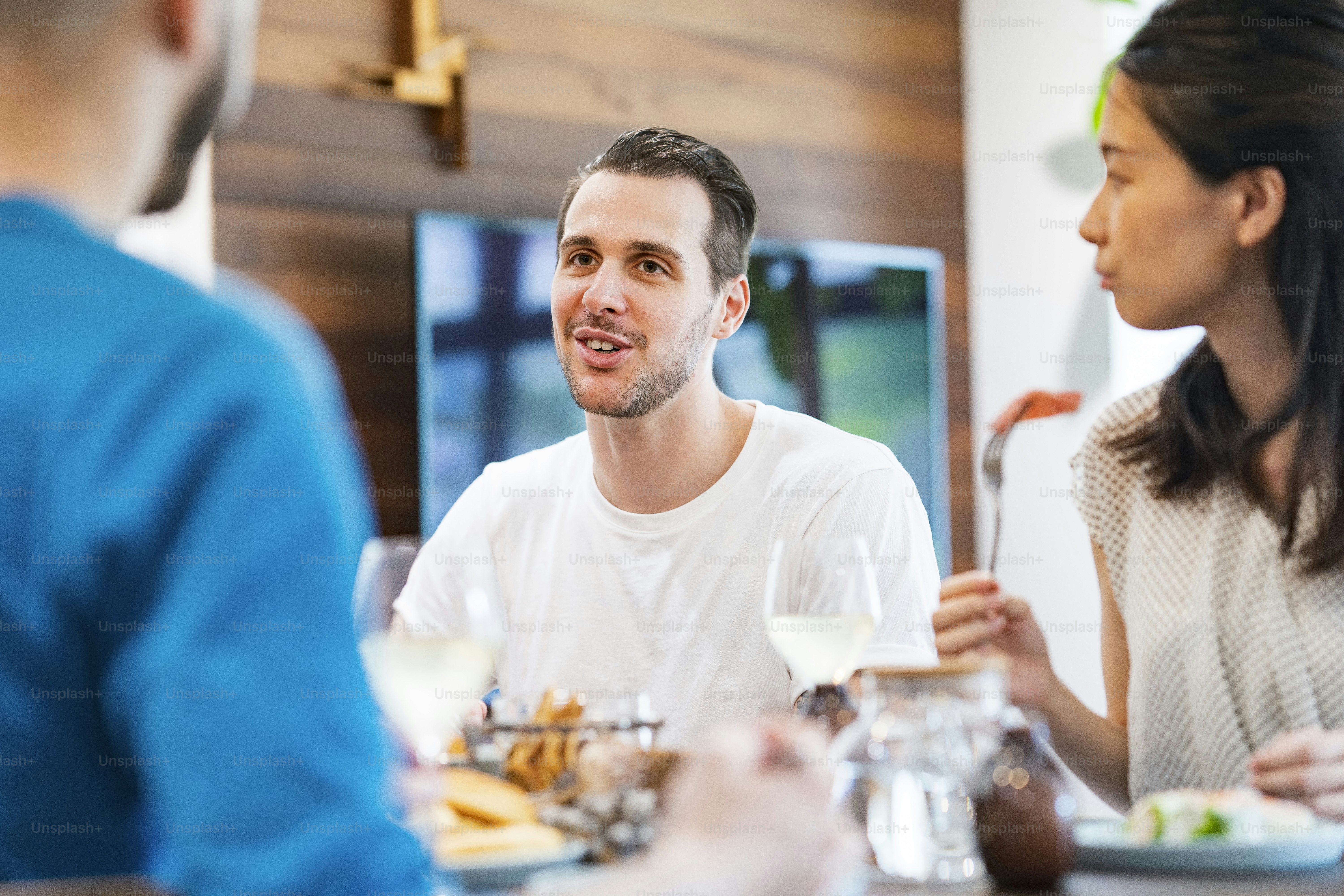 Men and women having a house party and having fun chatting