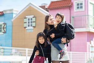 mom and her 2 kids taking commemorative photos with a smile