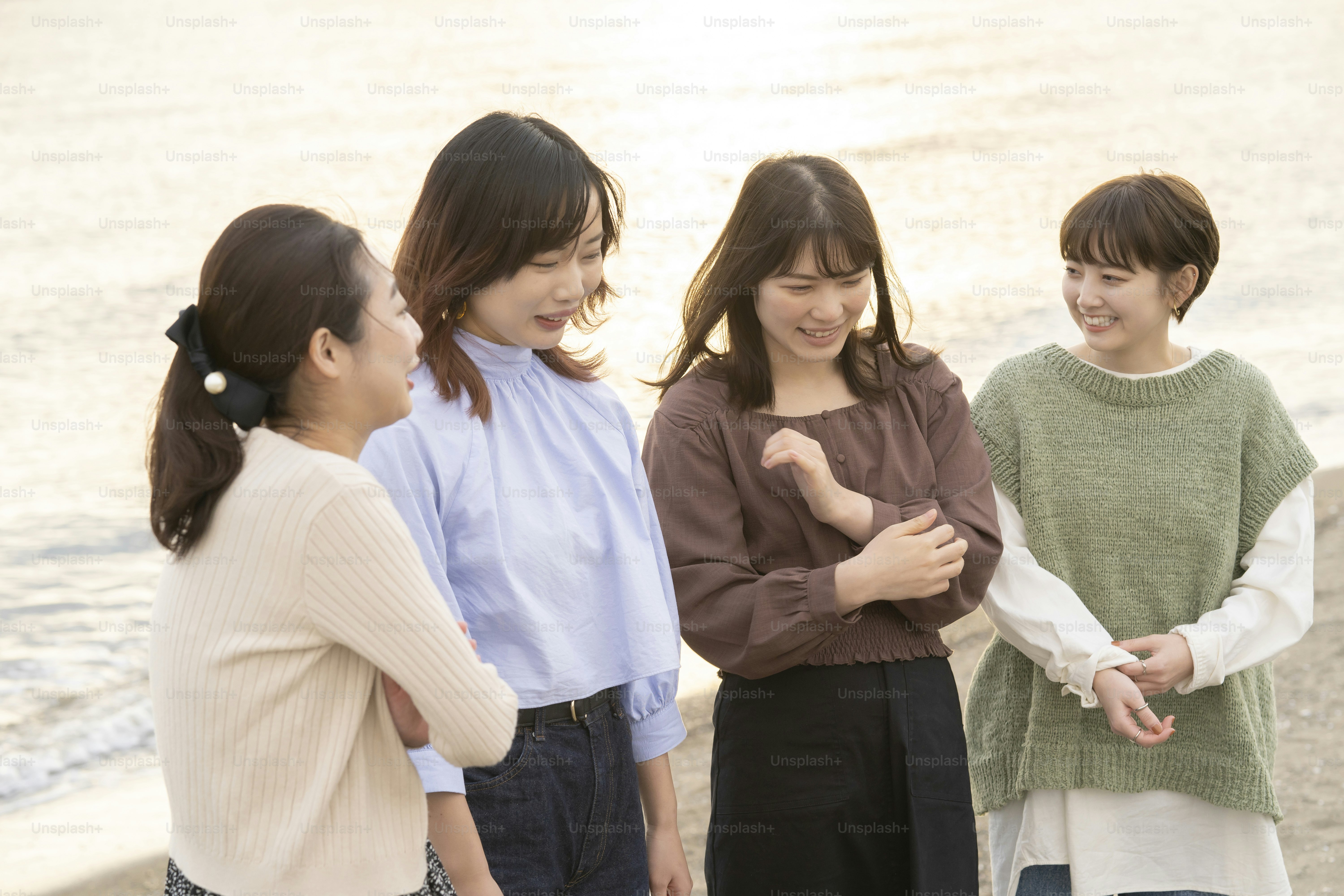 Four asian young women talking happily in the dusk photo – Sunset Image ...