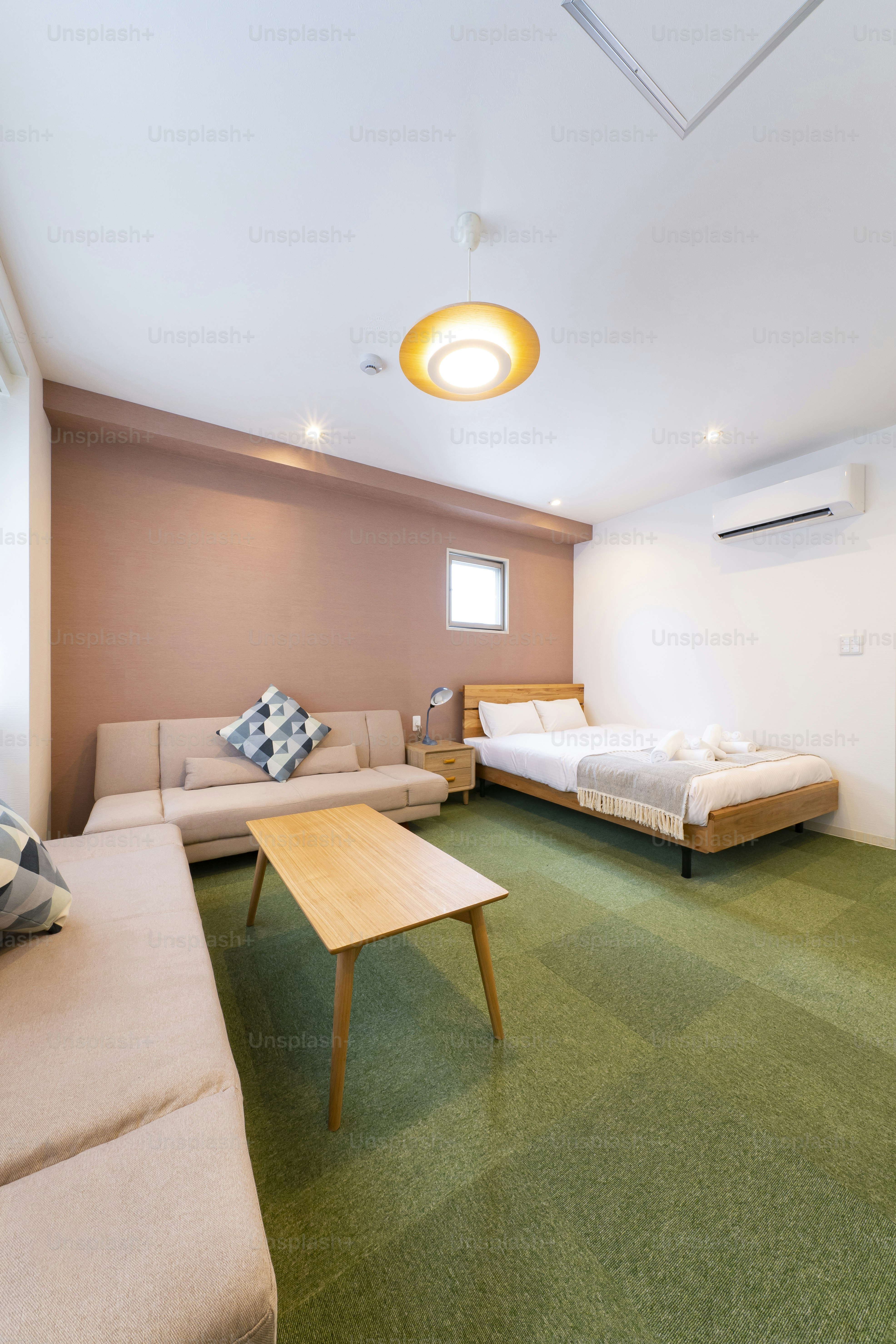 Hotel room with sofa, cushions, table and bed