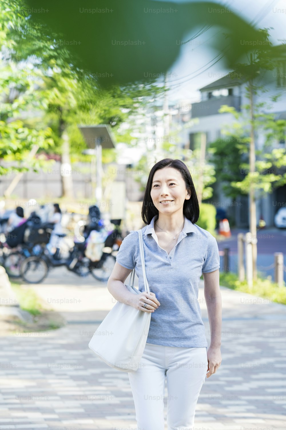 Middle-aged woman taking a walk with a relaxed look on fine day