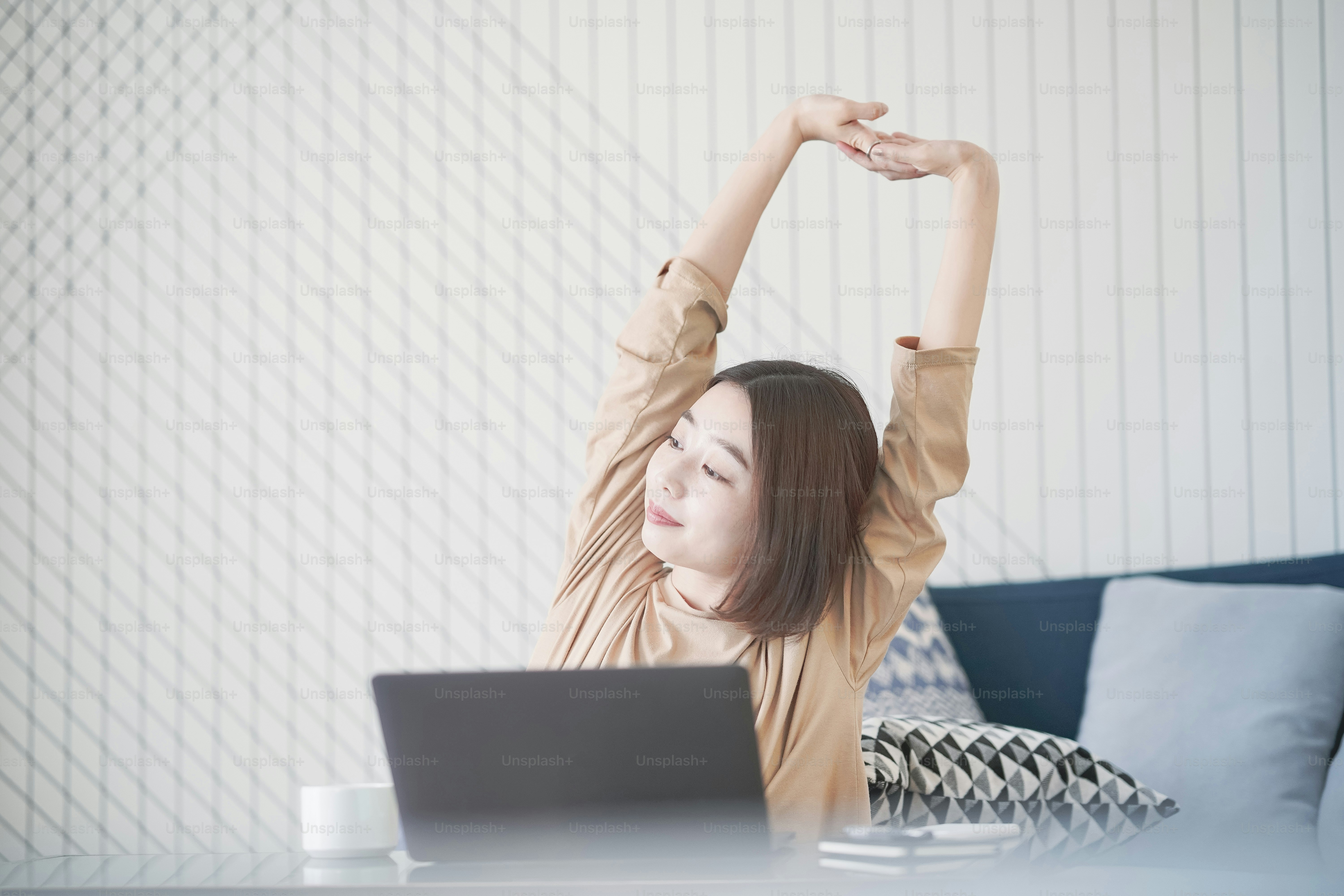 Asian young woman working remotely with laptop in room at home
