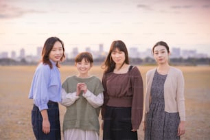 4 asian young women gathering to take a commemorative photo