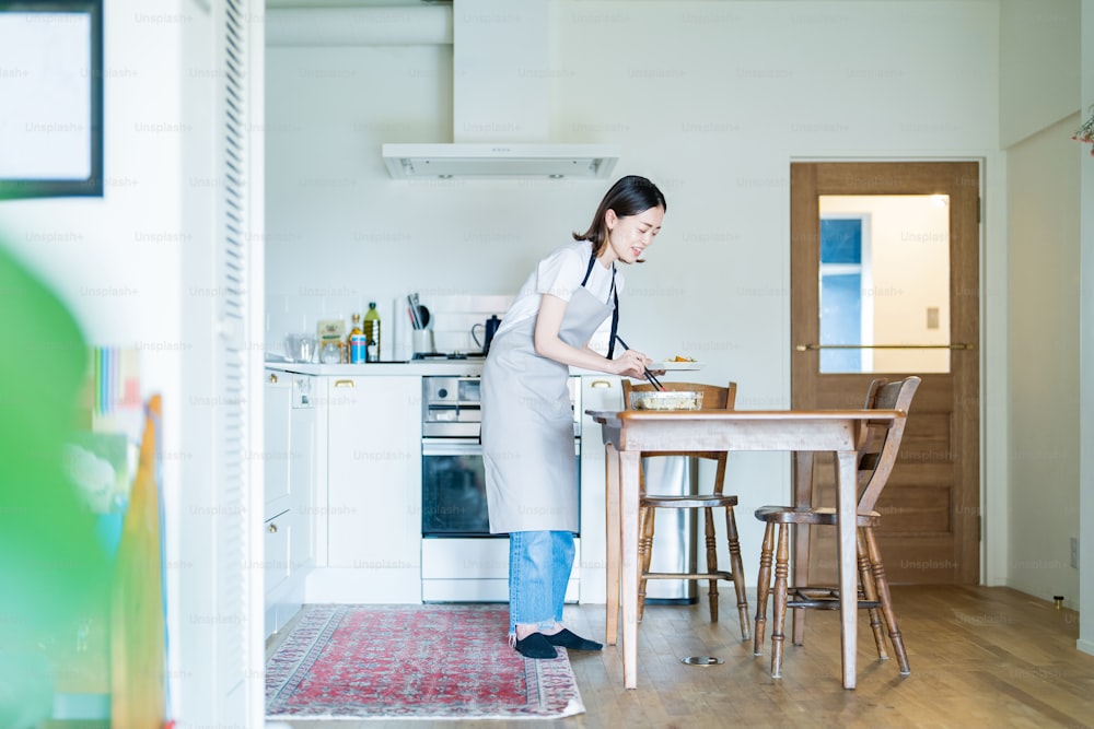 A woman who puts prepared side dishes on a plate