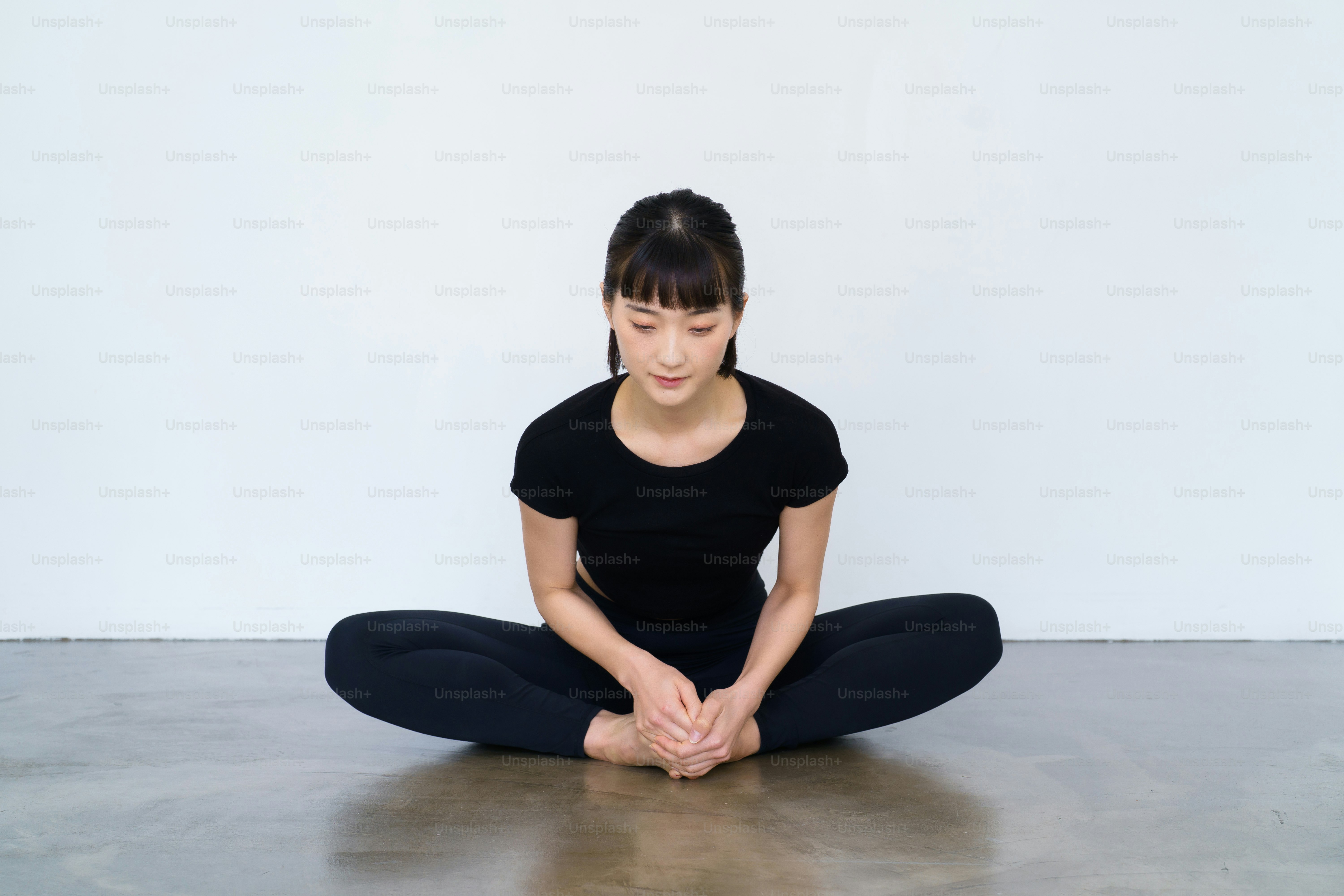 A woman doing yoga in a sole pose indoors
