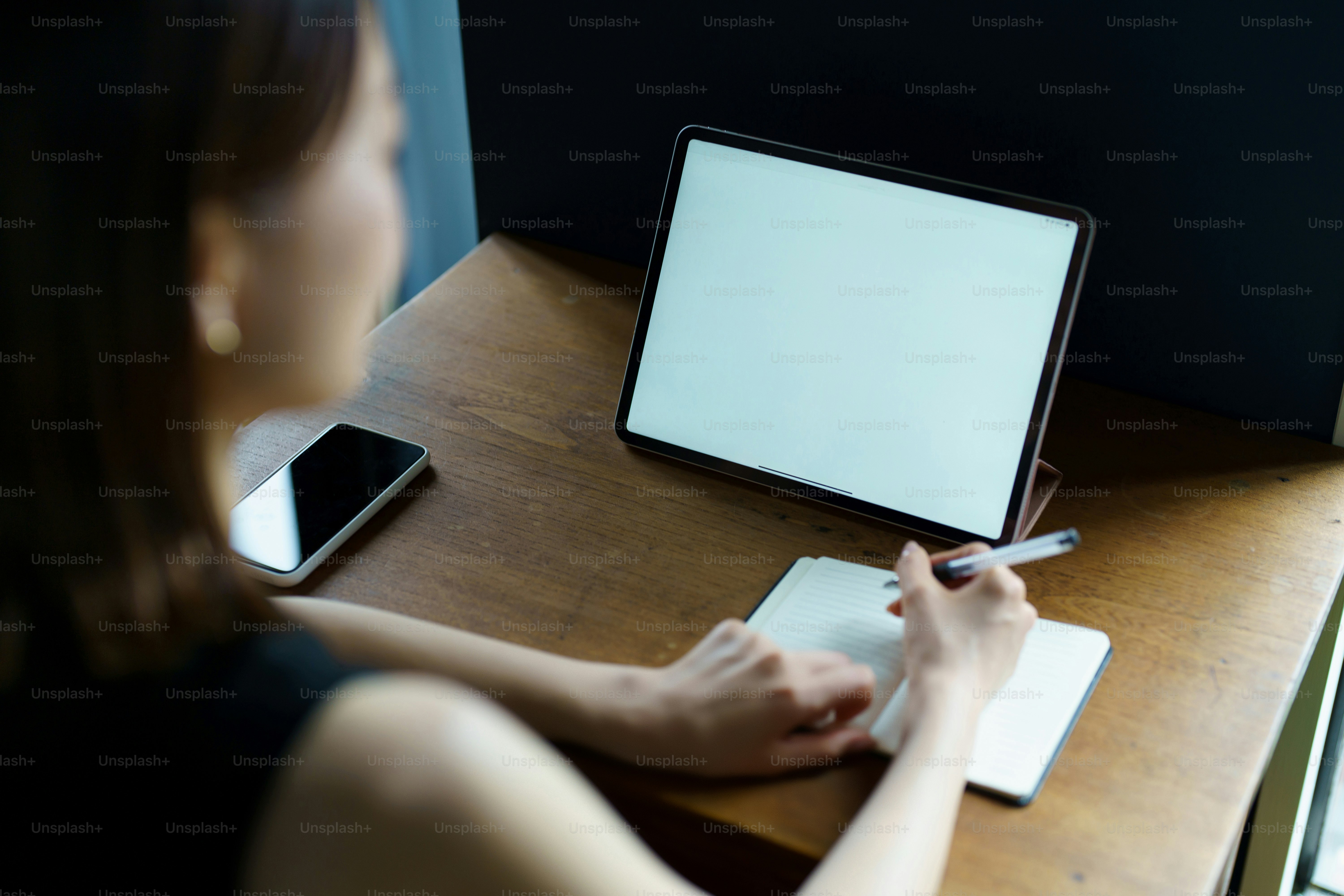 A woman who communicates online using a tablet PC in the room photo ...