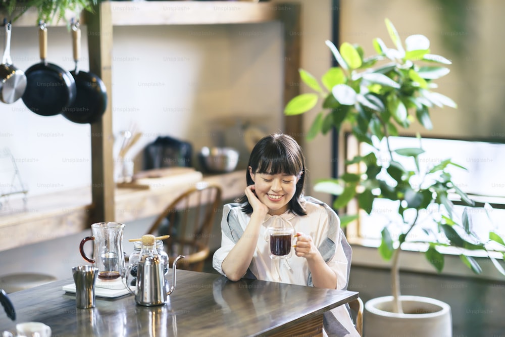A young woman brewing and drinking coffee in a calm atmosphere