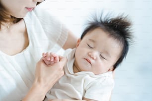 Asian baby to be hugged in a bright room