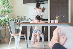 Asian girl drawing with colorful pens at the dining table at home