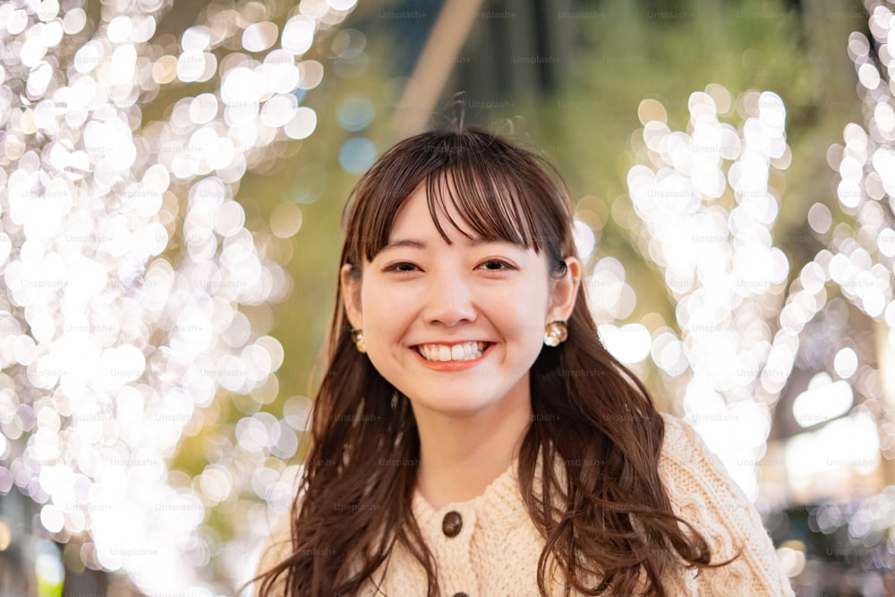 An Asian (Japanese) young woman watching the illuminations that color the night city