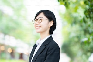 Asian young woman in a suit and glasses with smile