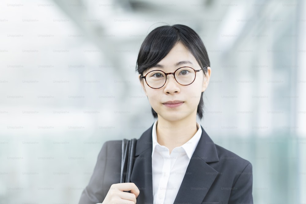 Asian young woman in a suit with a tense look