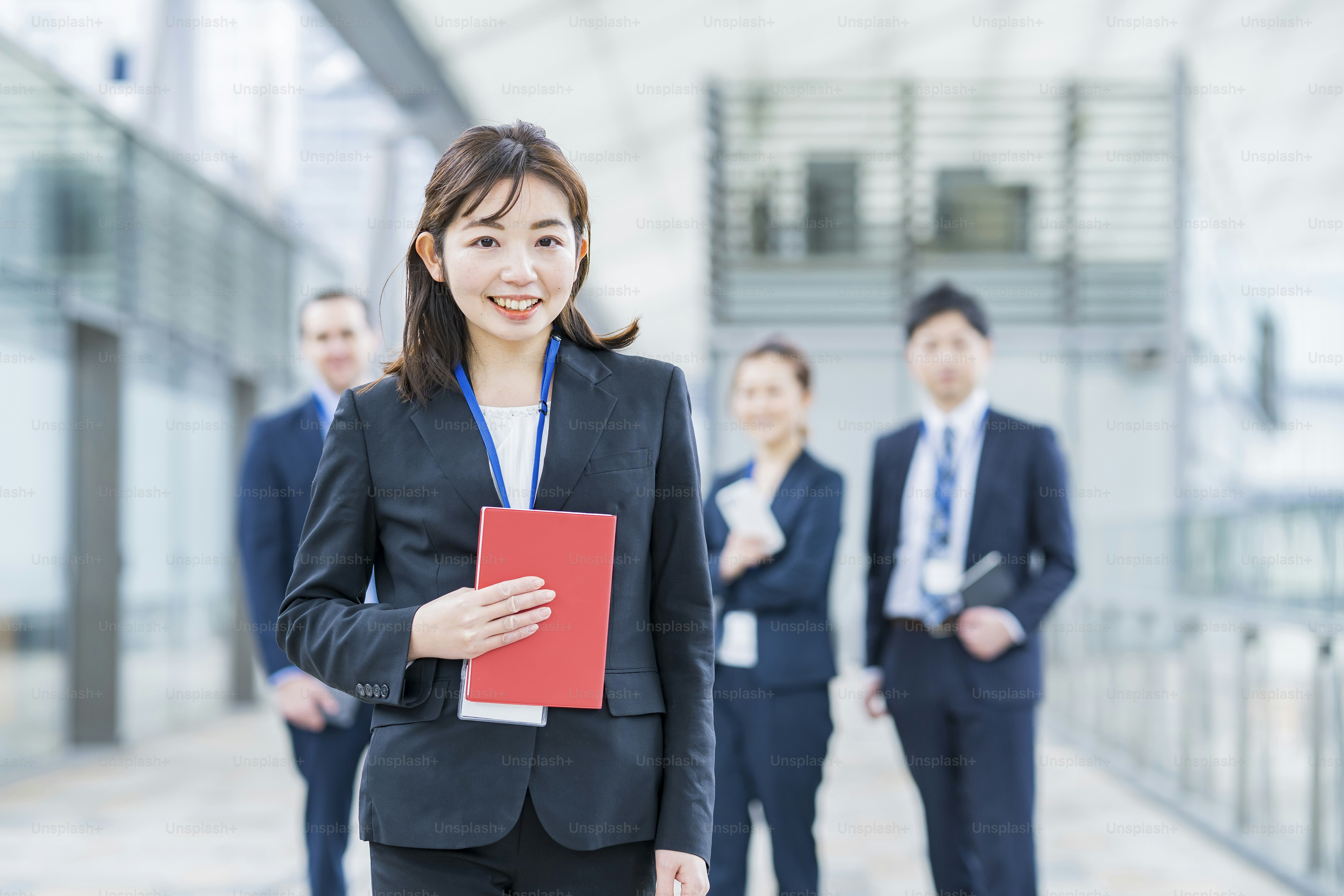 Smily asian business woman standing and her business team