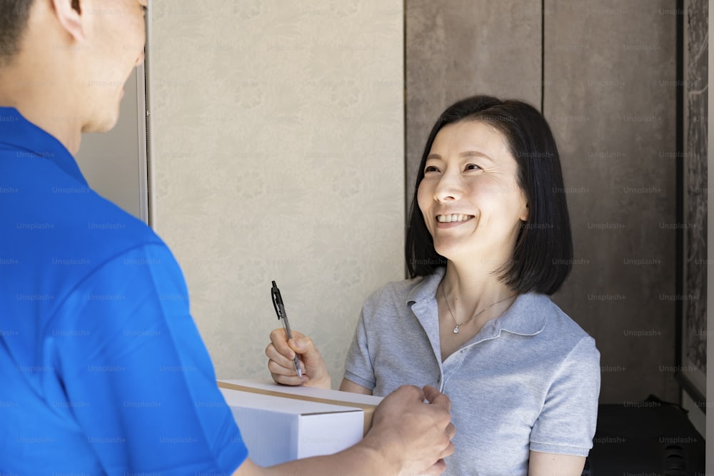 A woman who receives a courier and signs at the entrance