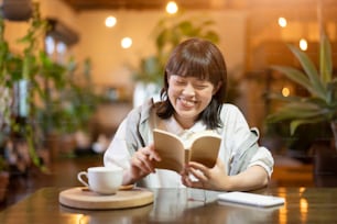 A young woman reading a book in a warm atmosphere