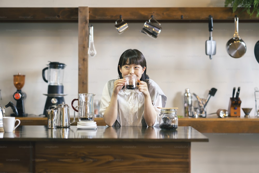 A young woman brewing and drinking coffee in a calm atmosphere