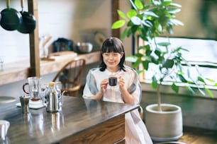 A young woman brewing and drinking coffee in a calm atmosphere