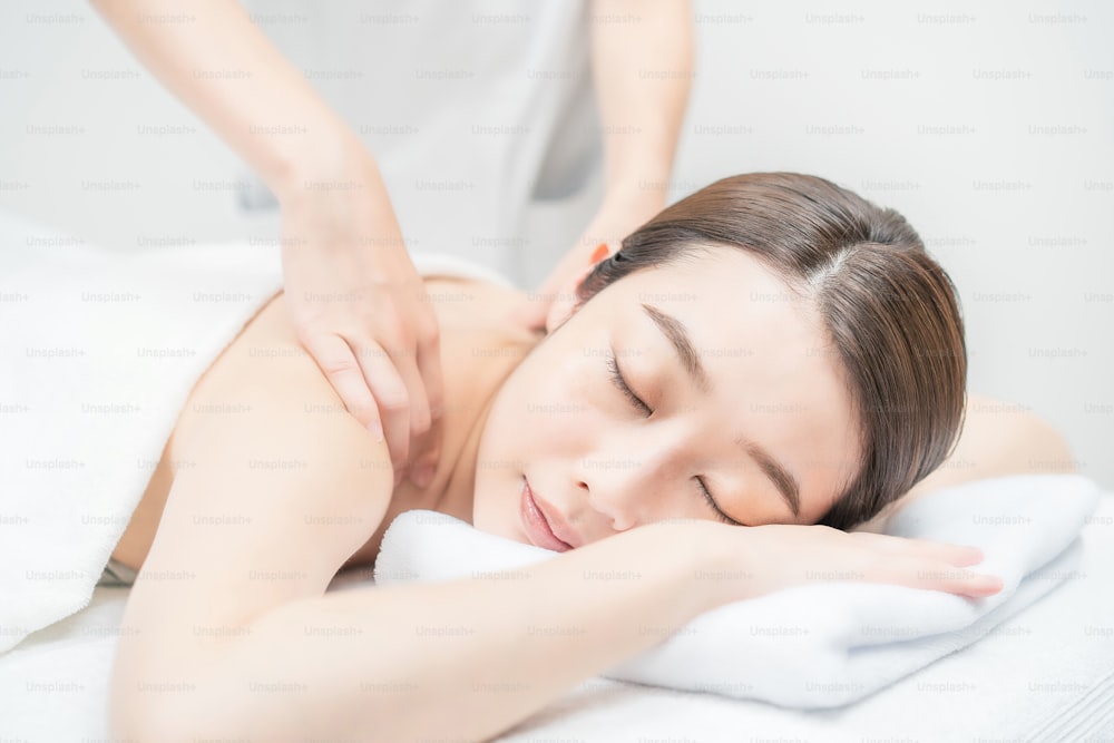 Asian young woman receiving a massage at an esthetic salon