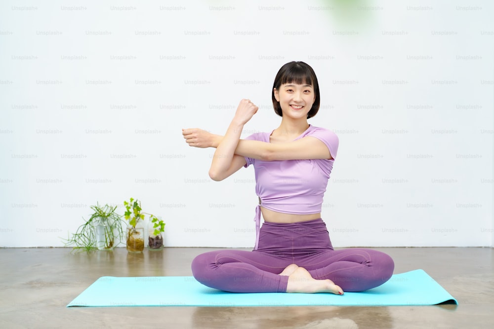 Asian young woman doing yoga and flexible exercise