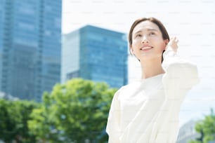 Young woman looking up at the sky (business woman)