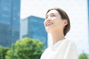 Young woman looking up at the sky (business woman)