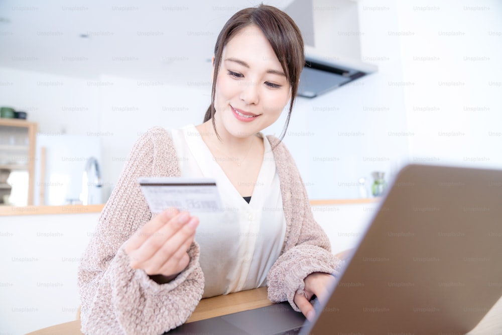 Young woman using credit card.