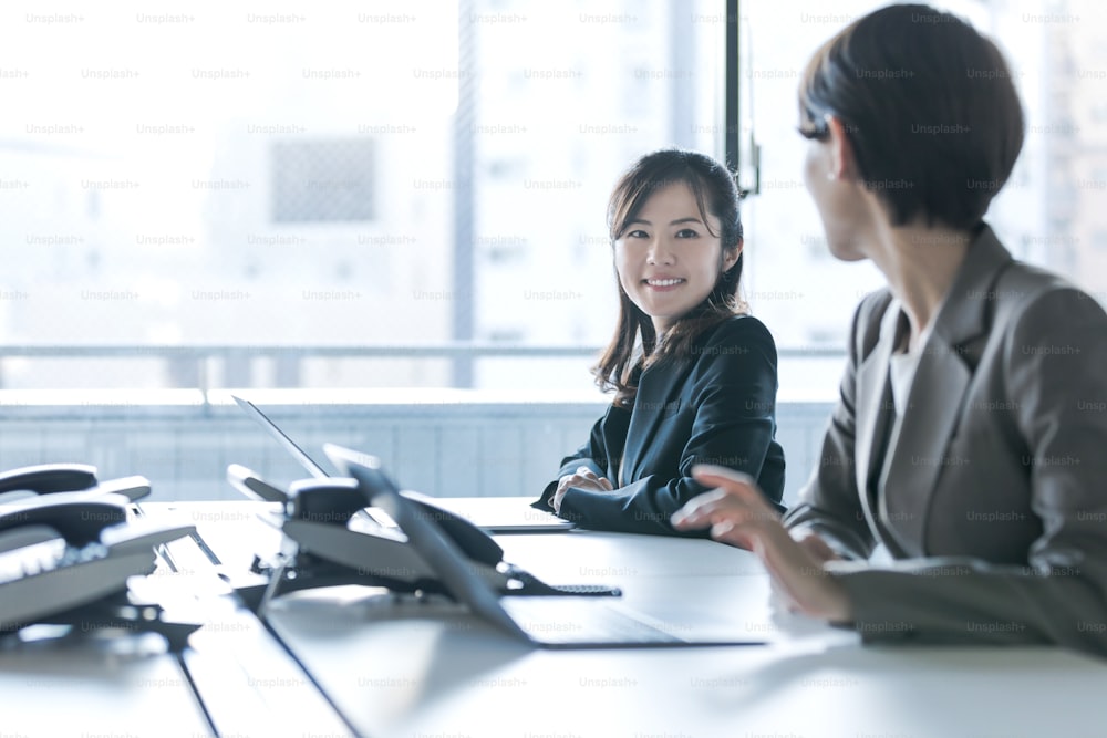 Businesswomen working in the office. Positive workplace concept.