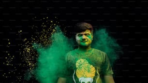 Young man celebrating holi with colors. holi is a festival of India. It is festival of colors and Joy. It is also called as Dhuleti.